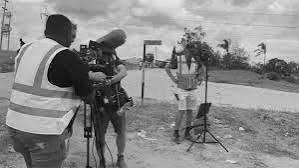 Filming on location with camera and crew