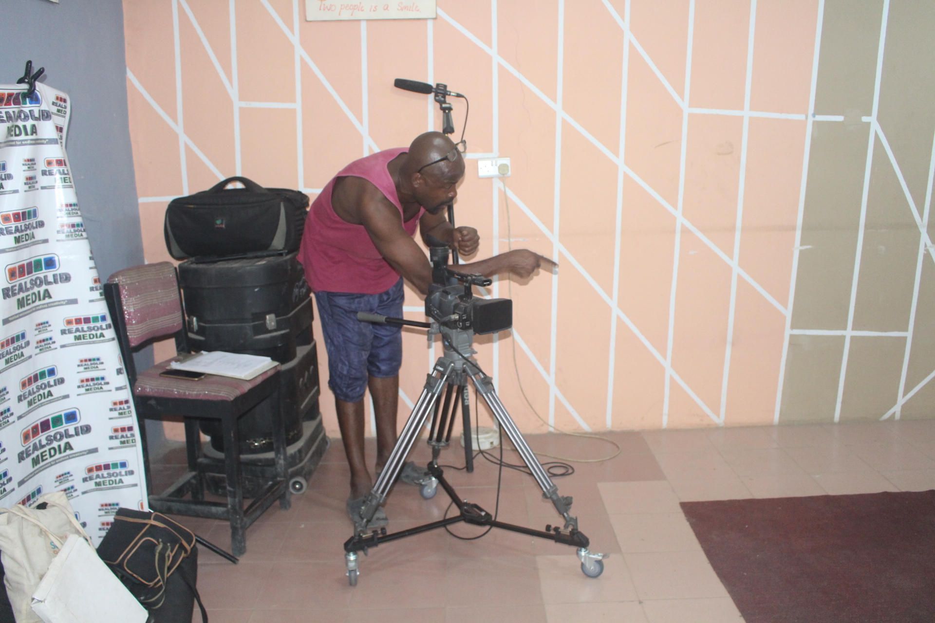 Kunle setting up the camera in the RealSolid Media studio